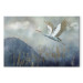 Wandbild A Heron in Flight - A Bird Flying Against the Background of Dark Blue Mountains Covered With Fog 151209